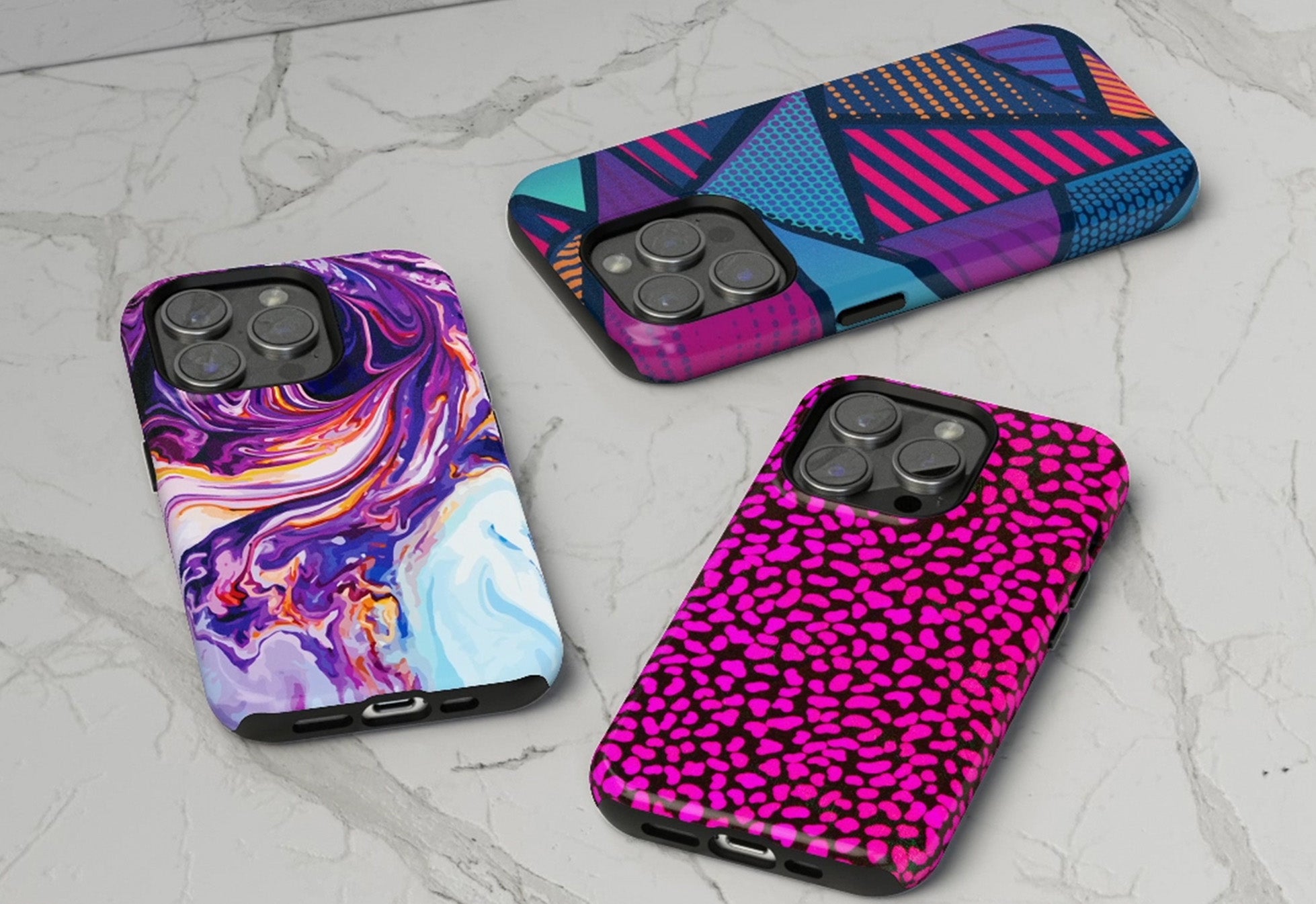 Three phone case mockups featuring vibrant geometric, liquid swirl, and pink leopard patterns on a marble surface for a print on demand store.